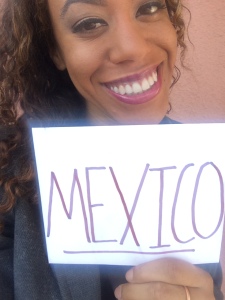 Picture of Jess holding up a sign of Mexico